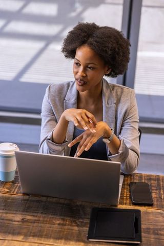 Confident Female Executive Delivering Presentation in Modern Office