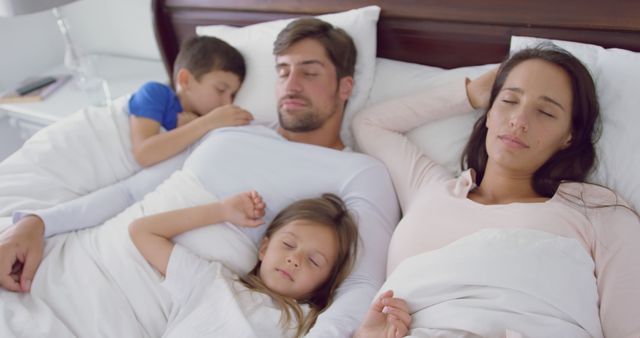 Happy Family Sleeping Together in Comfortable Bed - Download Free Stock Images Pikwizard.com