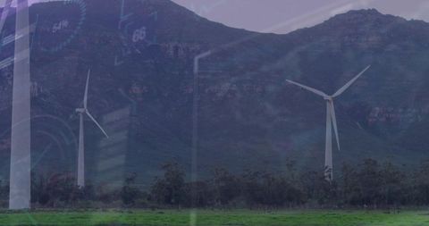 Wind turbines generating clean energy at mountain base with subtle digital HUD overlay