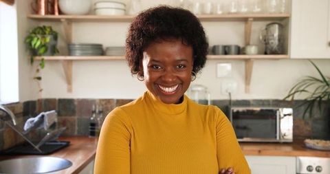 Confident Woman Smiling in Cozy Home Kitchen