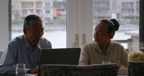 Senior Couple Engaging with Technology in Cozy Home Setting