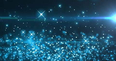 Glowing blue bokeh lights and sparkling starbursts with lens flare and abstract depth