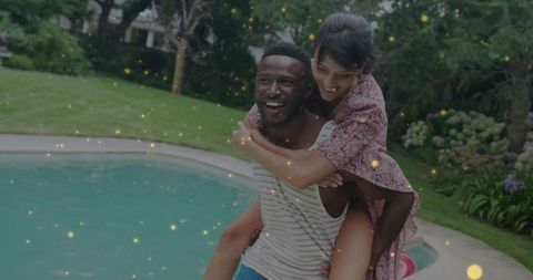 Joyful Couple Enjoying Summer Festivities by Backyard Pool
