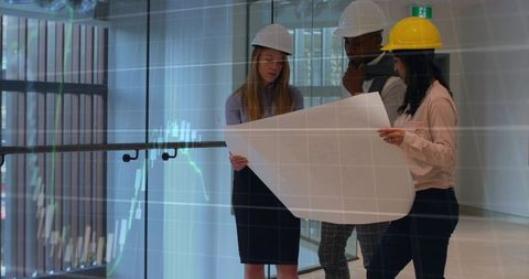 Engineers reviewing blueprint in office atrium with glass railing and data reflections