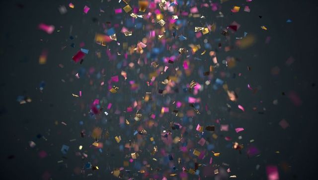 Vibrant Confetti Falling Against Dark Gray Background