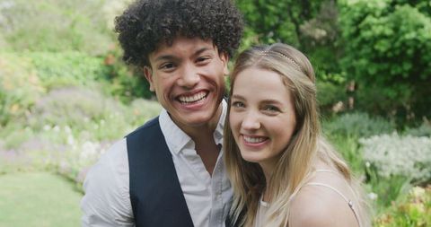 Joyful Couple Smiling Confidently at Outdoor Celebration