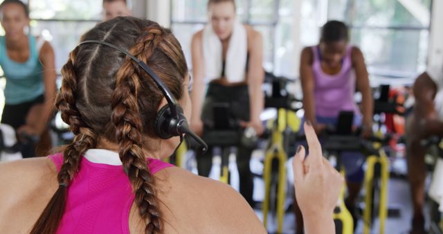 Group Indoor Cycling Class with Trainer Using Headset - Download Free Stock Images Pikwizard.com