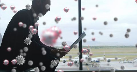 Business Traveler Engaged in Documents Amidst Virus Illustrations