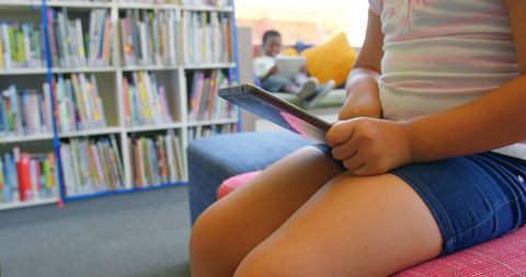 Girl Using Tablet in Colorful School Library, Encouraging Learning - Download Free Stock Images Pikwizard.com