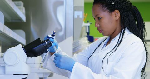 Female scientist working with equipment in laboratory setting