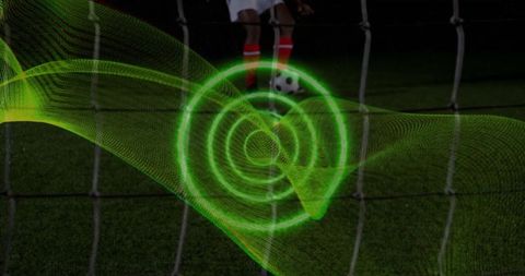 Soccer player penalty kick with neon light spiral motion