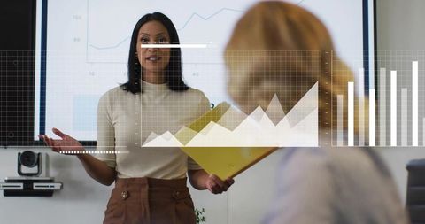 Businesswoman Presenting Sales Analytics with Digital Charts Overlay in Modern Boardroom