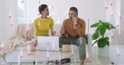 Collaborating Professionals Working on Digital Project in Cozy Living Room with Laptop