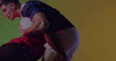 Dynamic Rugby Tackle with Jersey Clad Athletes in Studio