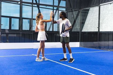Teammates High-Fiving on Indoor Padel Court