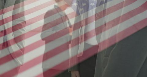 American flag overlay on business leaders standing in formal suits and coats