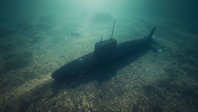 Resting Military Submarine Silhouette on Sandy Seabed Under Hazy Green Ocean Mysterious Light