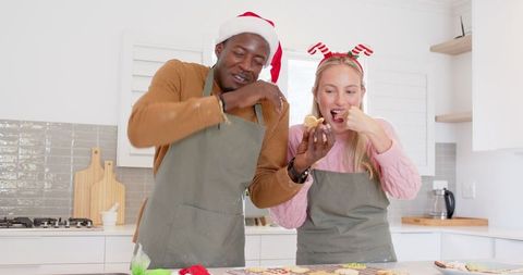 Festive Diverse Couple Enjoying Homemade Christmas Cookies