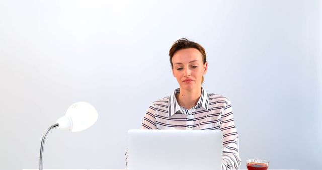 Focused Woman Working on Laptop with Lamp on Desk - Download Free Stock Images Pikwizard.com