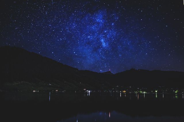 Starry Night Sky Over Calm Lake and Forested Hills - Download Free Stock Photos Pikwizard.com