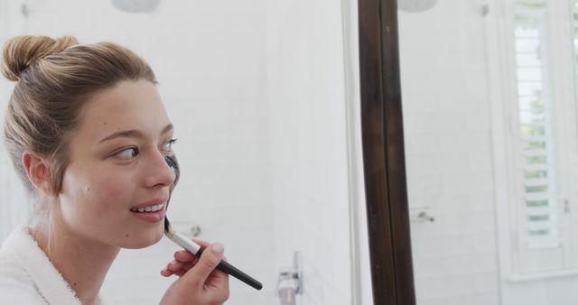 Young Woman Applying Makeup in Front of Bathroom Mirror - Download Free Stock Images Pikwizard.com