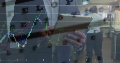 Caucasian Businessman Analyzing Data on Tablet with Digital Overlay