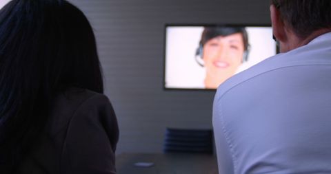 People Viewing Presenter on Television Screen in Modern Setting - Download Free Stock Images Pikwizard.com