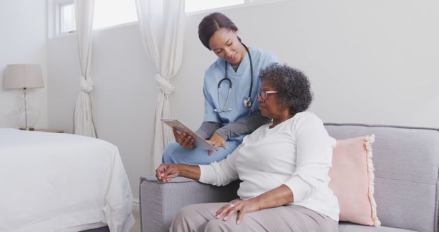 Healthcare Professional Discussing Report with Elderly Patient at Home - Download Free Stock Images Pikwizard.com