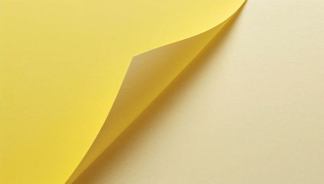 Yellow paper corner peeling to reveal cream layer minimal duotone background soft shadow