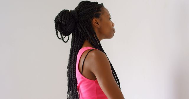 Focused biracial woman with black dreadlocks wearing sports clothes and exercising at gym - Download Free Stock Photos Pikwizard.com