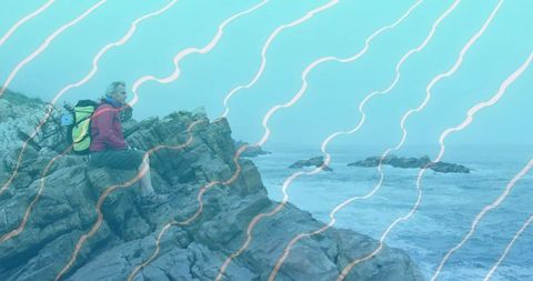 Adventurous hiker taking in majestic coastal views for inspiring escapes