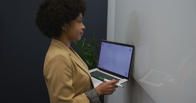 Businesswoman giving presentation using laptop and whiteboard - Download Free Stock Images Pikwizard.com