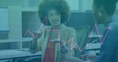 Business professional discussing data visualizations in modern office