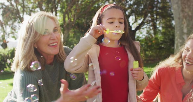 Multigenerational Family Playing with Bubbles in Sunny Park - Download Free Stock Images Pikwizard.com