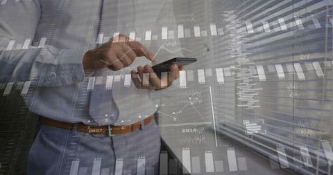 Businessman Interacting with Smartphone and Data Analytics Overlay