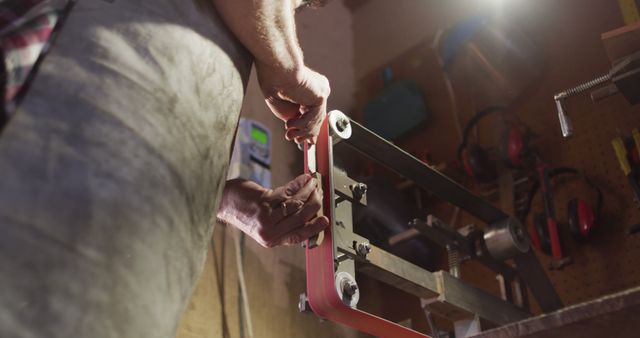 Craftsman Adjusting Belt Sander in Workshop, Low Angle View - Download Free Stock Images Pikwizard.com