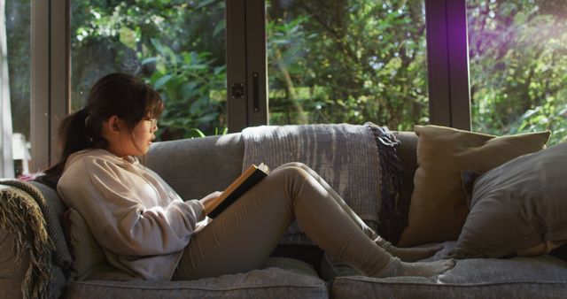 Young Girl Smiling Nicely While Reading a Story Book in Cozy Environment - Download Free Stock Images Pikwizard.com