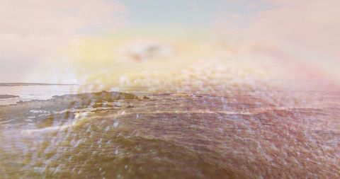 Tranquil sunrise reflecting on serene ocean waves and rocky outcrops