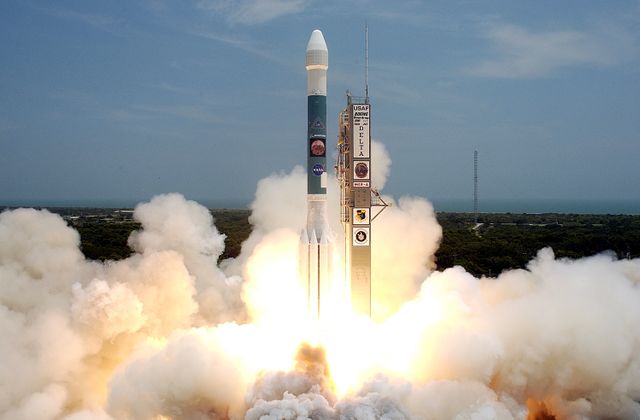 The image depicts the remarkable launch of the Delta II rocket carrying the Mars Exploration Rover 'Spirit' on time from Launch Complex 17-A, Cape Canaveral Air Force Station. Strong visual impact is created by the dynamic liftoff, surrounded by smoke and steam. Ideal for illustrating topics related to space exploration, science, technology, and NASA missions.