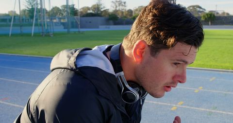 Young Man Catching Breath After Workout on Outdoor Track