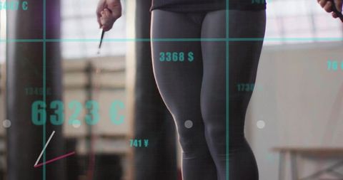 Woman jumping rope in gym with currency overlay