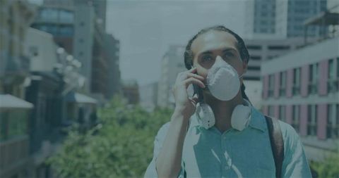 Commuter on City Street with Mask and Headphones Using Smartphone