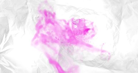 Swirling magenta pigment cloud drifting across crumpled white paper with speckles