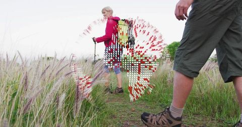 Woman hiking trail in scenic nature setting with backpack & wild grass