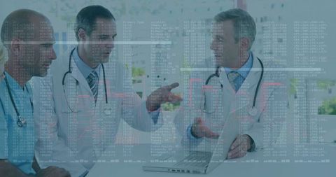 Doctors Analyzing Medical Research Data on Laptop in Conference Room