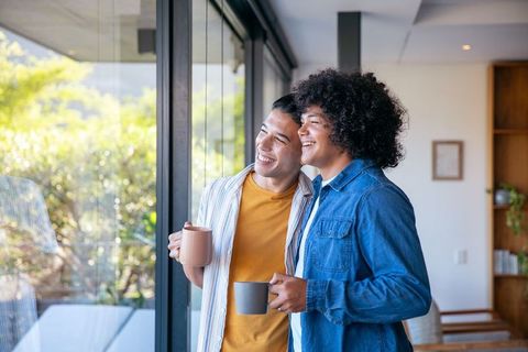 Friends enjoying coffee in modern bright living room