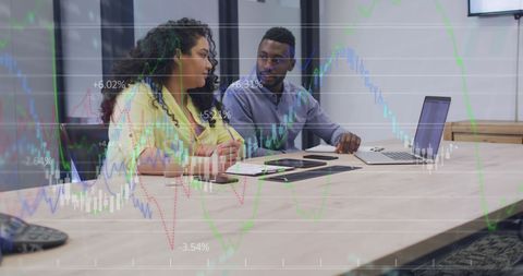 Diverse Colleagues Collaborating on Business Data in Office