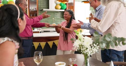 Happy Multiracial Seniors Celebrating Birthday at Home