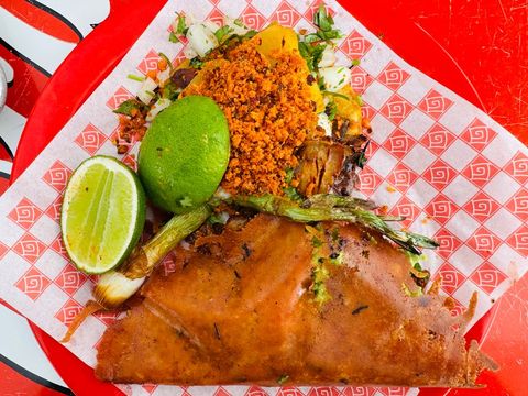 Mexican tlayuda and tacos with chorizo, fresh lime and spring onions