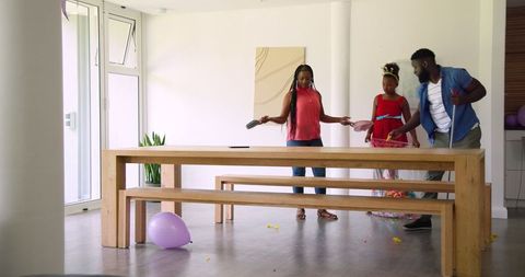 Family Cleaning Up Confetti After Event Celebration